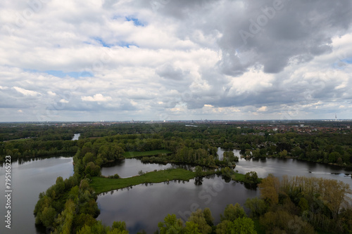 Cloudy sky over a lake surrounded by trees, a serene natural landscape Hanover Germany