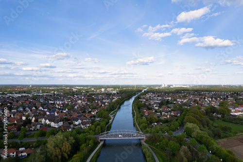 Aerial view of a river with trees, bridge, and urban design Mittellandkanal Seelze Hanover Germany