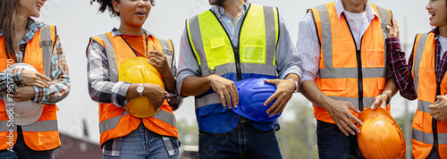 Engineer team holding hardhat standing in row ready for work.Worker diversity group wearing vest,ppe for safety in site train garage.Expert construction project manager leadership.banner cover design.