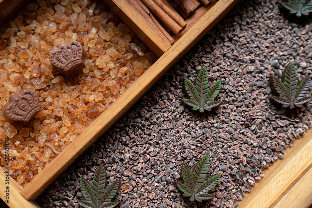 Handcrafted chocolates in leaf and crown shapes. Delicious dessert in wooden box. Handcrafted chocolates in leaf and crown shapes. Delicious dessert in wooden box.
