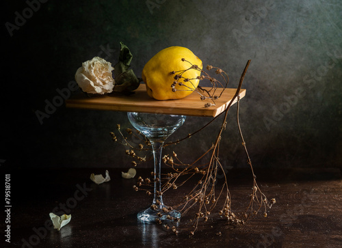 Modern still life with quince and dry branches on a dark background
