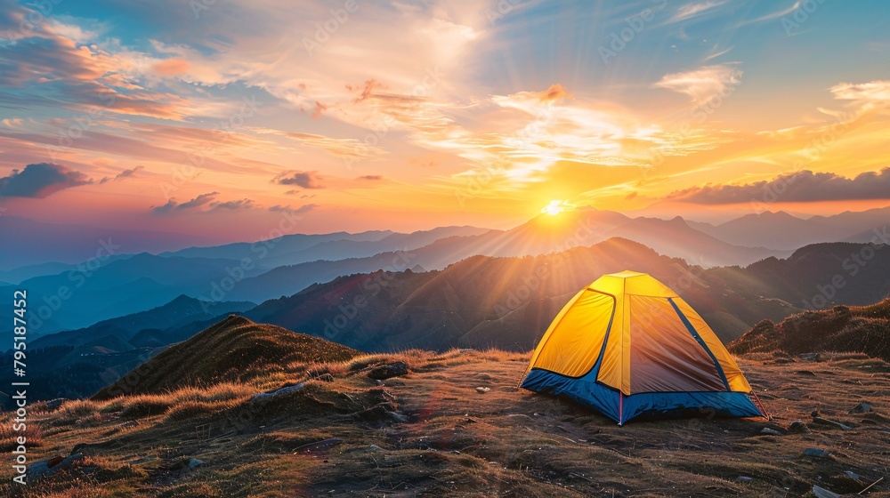 Camping in the mountains at sunset. Beautiful summer landscape with yellow tent.