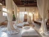 A white room with curtains and pillows. The room is very clean and has a very calming atmosphere