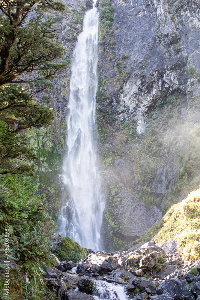Devils Punchbowl waterfall cascades amid lush NZ greenery, a jewel of Arthur's Pass