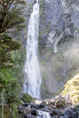 Devils Punchbowl waterfall cascades amid lush NZ greenery  a jewel of Arthur s Pass