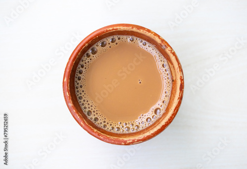 A cup of Milk tea or Dudh Cha in a traditional natural clay cup. Top view photo