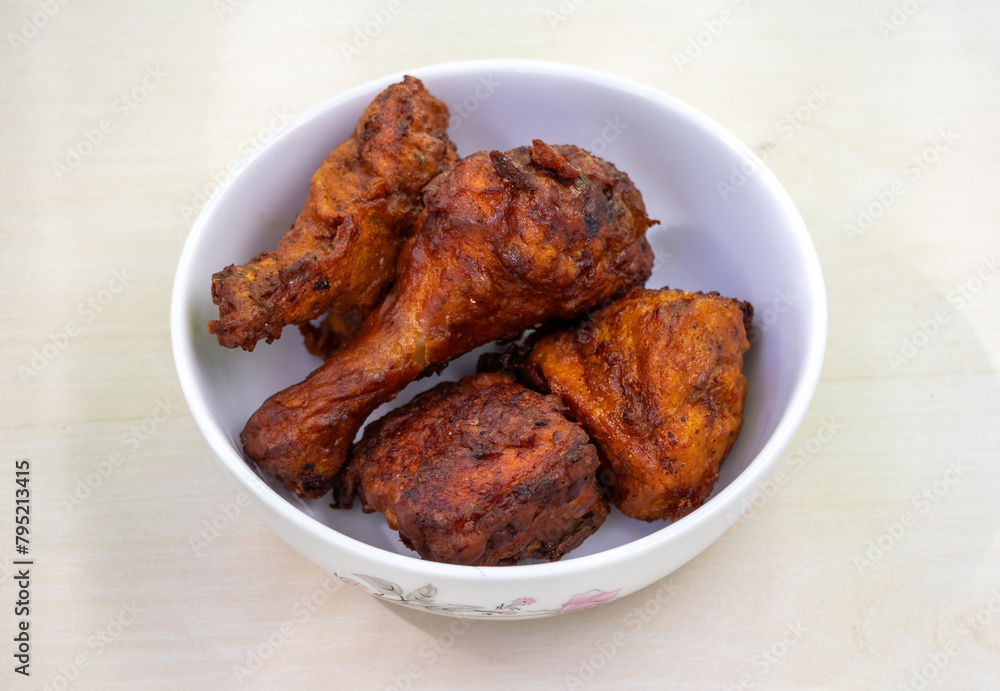 Delicious homemade fried chicken in a white bowl. Bangladeshi authentic Chinese restaurant-style chicken fry. Delicious homemade fried chicken in a white bowl. Bangladeshi authentic Chinese restaurant-style chicken fry.