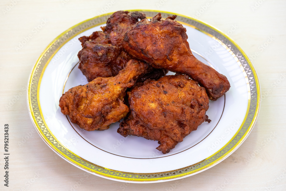 Delicious fried chicken on a white plate. Bangladeshi Chinese restaurant-style chicken fry. Delicious fried chicken on a white plate. Bangladeshi Chinese restaurant-style chicken fry.
