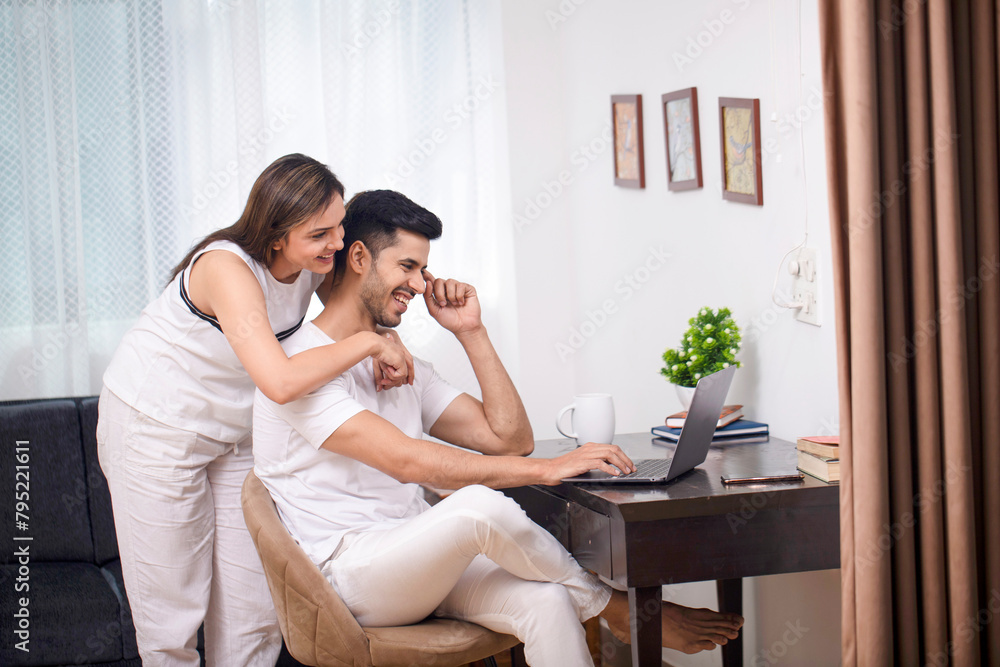 Stylish Couple Smiling While Looking At Laptop Screen
Stylish Couple Smiling While Looking At Laptop Screen