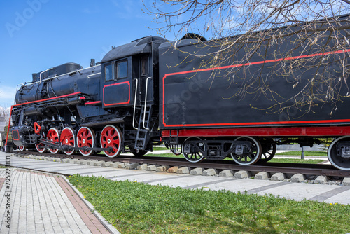 A steam locomotive with a steam power plant using steam engines as an engine. Mainline passenger steam locomotive. Ancient railway transport. Transportation of goods by rail.