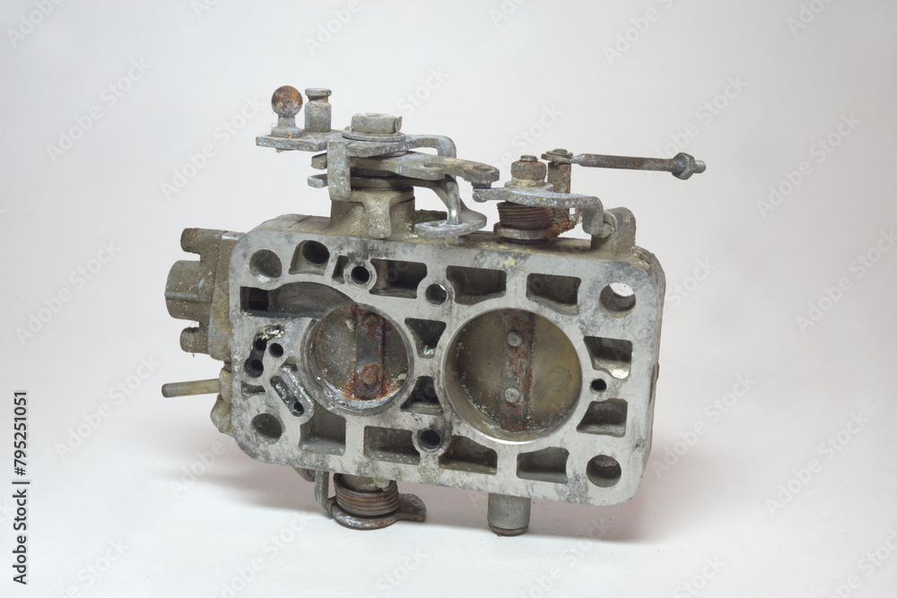throttle assembly body, lower part of old dual port carburetor. Showing metal housing and throttle valves with corrosion on surfaces throttle assembly body, lower part of old dual port carburetor. Showing metal housing and throttle valves with corrosion on surfaces