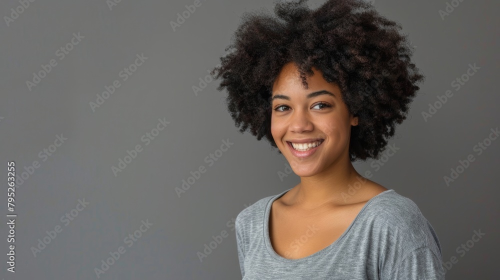 Black woman with afro or arms crossed by advertisement space on grey studio background, company marketing or promotion mockup. Portrait, smiling, or joyful creative designer and us branding logo Black woman with afro or arms crossed by advertisement space on grey studio background, company marketing or promotion mockup. Portrait, smiling, or joyful creative designer and us branding logo
