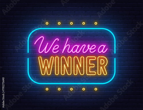 We Have a Winner Neon Sign on brick wall background.