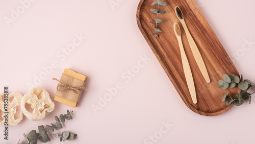 Bamboo toothbrushes on a wooden tray