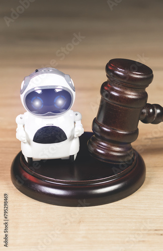 Judge Hammer for adjudication to the Real Robot. Adjudgement Gavel with wooden stand. Lawyer decision about Digital  assistant. Law and justice. Court of law. 
