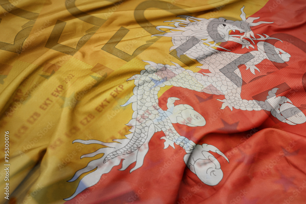 waving colorful national flag of bhutan on a euro money banknotes background. finance concept.. waving colorful national flag of bhutan on a euro money banknotes background. finance concept..
