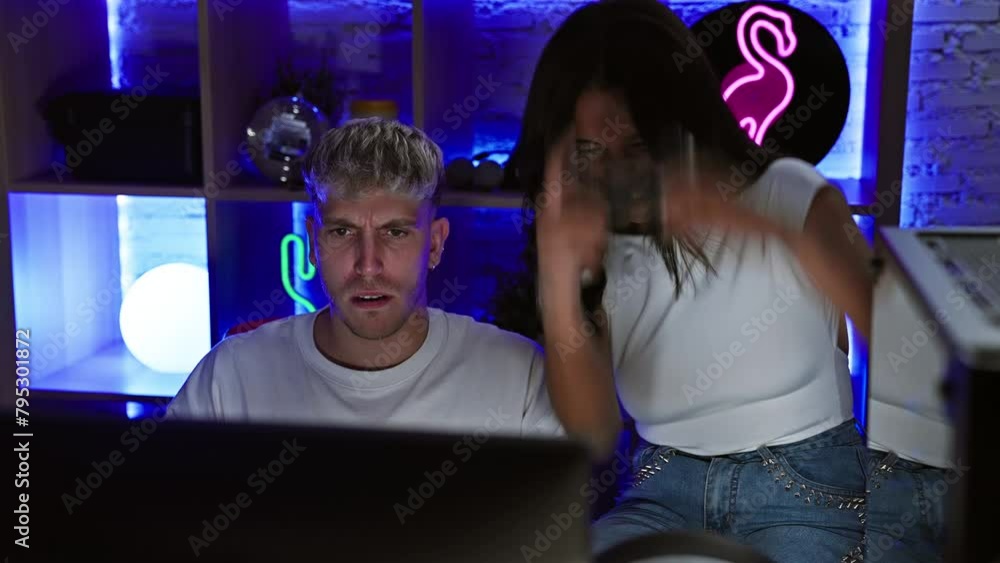 A man and woman bond over a video game in a neon-lit home gaming room. A man and woman bond over a video game in a neon-lit home gaming room.