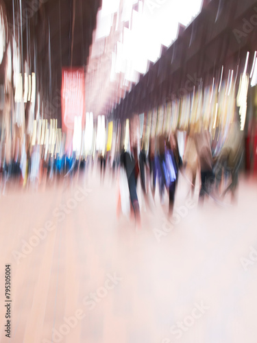 People, walking and travel with motion blur of busy mall or building for commute in city or town square. Group, community or pedestrians moving with crowd, population or public sector in urban area