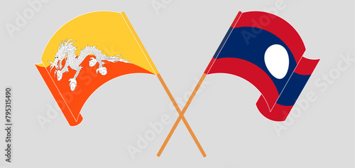 Crossed and waving flags of Bhutan and Laos