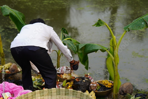 photograph of a man worship chhath puja images  photo