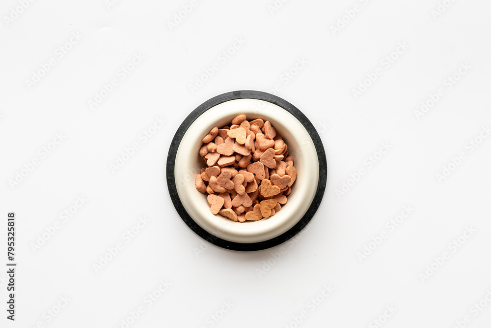 Bowl of biscuits for pets - food in a shape of heart, top view Bowl of biscuits for pets - food in a shape of heart, top view