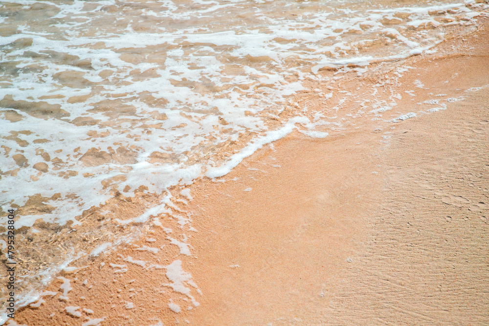 Wet coastal sand and sea shore water, abstract natural background