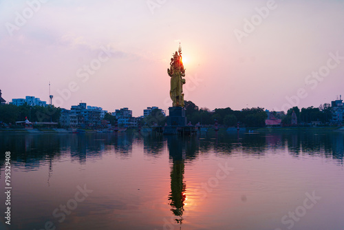 The Statue of Hindu god Lord Shiva in Sursagar Lake is seen at sunset in Vadodara city in the state of Gujarat. Concept of hinduism religion photo