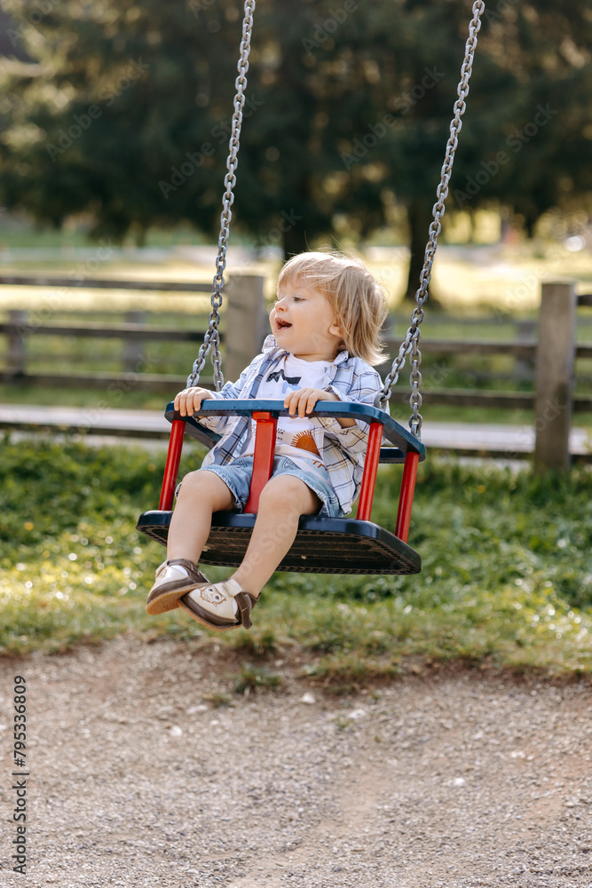 little child swinging on swing little child swinging on swing