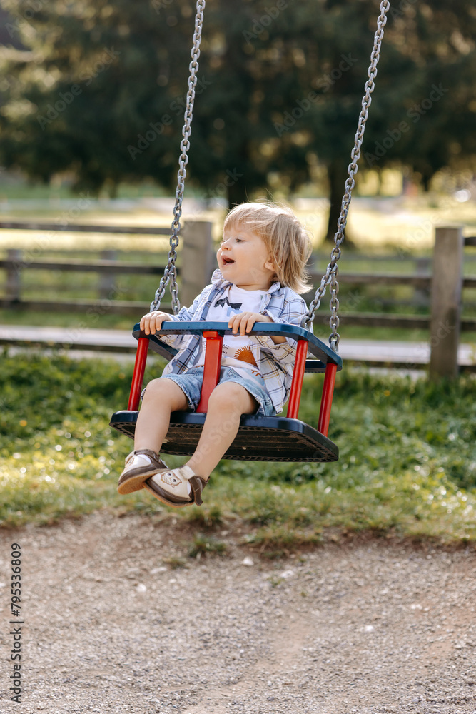 little child swinging on swing