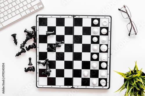Competition in business concept. Chess board on office table, top view