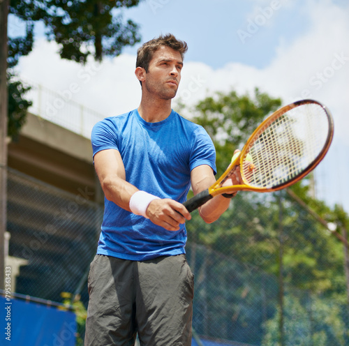 Man, racket and serve in outdoor tennis match, game and court for competition or practice. Male person, athlete and ready for training or exercise, workout and hobby for action and play fitness © peopleimages.com