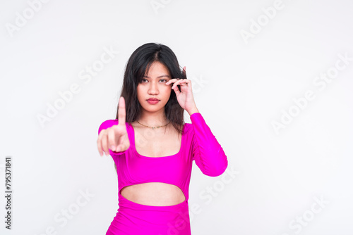 Young woman in magenta dress rejecting or saying no  isolated on white
