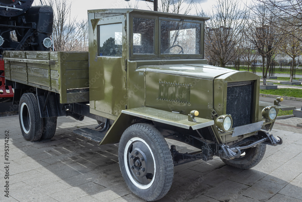 A Soviet medium-tonnage truck with a wooden body. The vintage car is made on a frame chassis with springs. The history of the creation of trucks. Cargo transportation in the last century.
