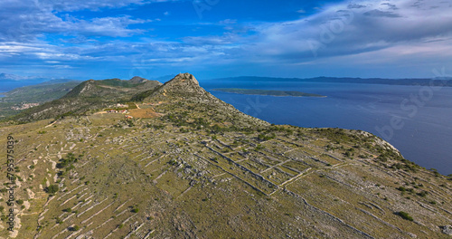 AERIAL: Panoramic drone view of traditional terraced fields on Hvar island.