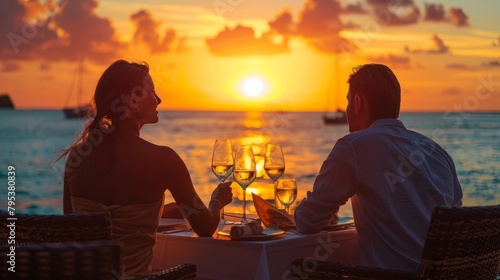 A couple celebrating their anniversary with a romantic dinner at sunset