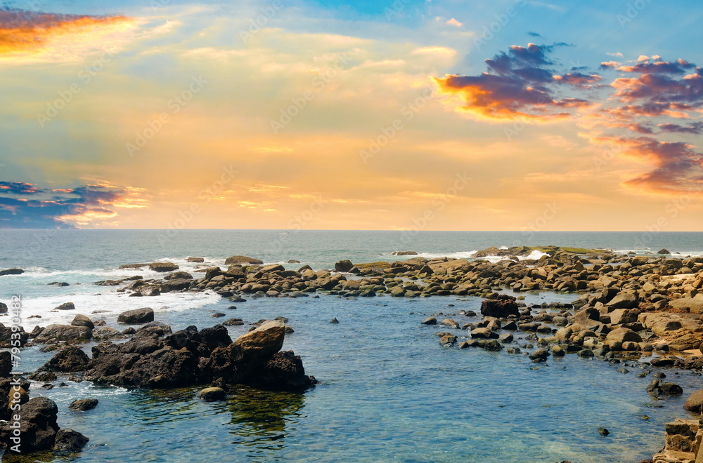 Fototapeta premium Picturesque tropical beach with boulders and sunrise.
