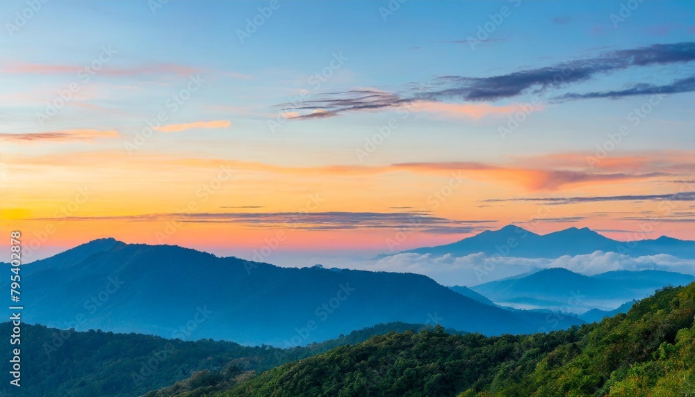 beautiful sunrise over the green mountains in morning light with fluffy clouds on a bright blue sky nature freshness concept