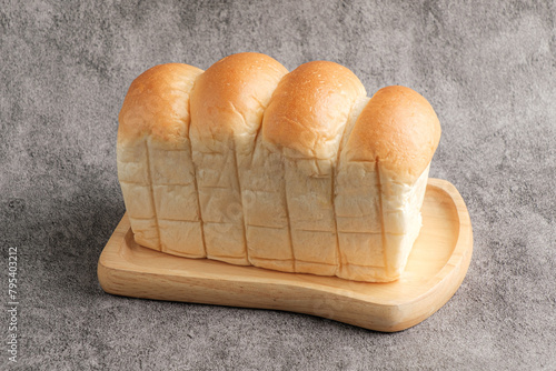 Japanese Hokkaido Milk Bread Soft and Fluffy Bun White Bread on a Wooden Plate