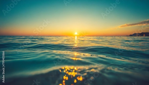 beautiful closeup sea water surface sunset sunrise gold blue colors calm soft waves relaxing horizon dream fantasy shallow focus blur seascape sky tranquil peaceful nature pattern mediterranean #795403866