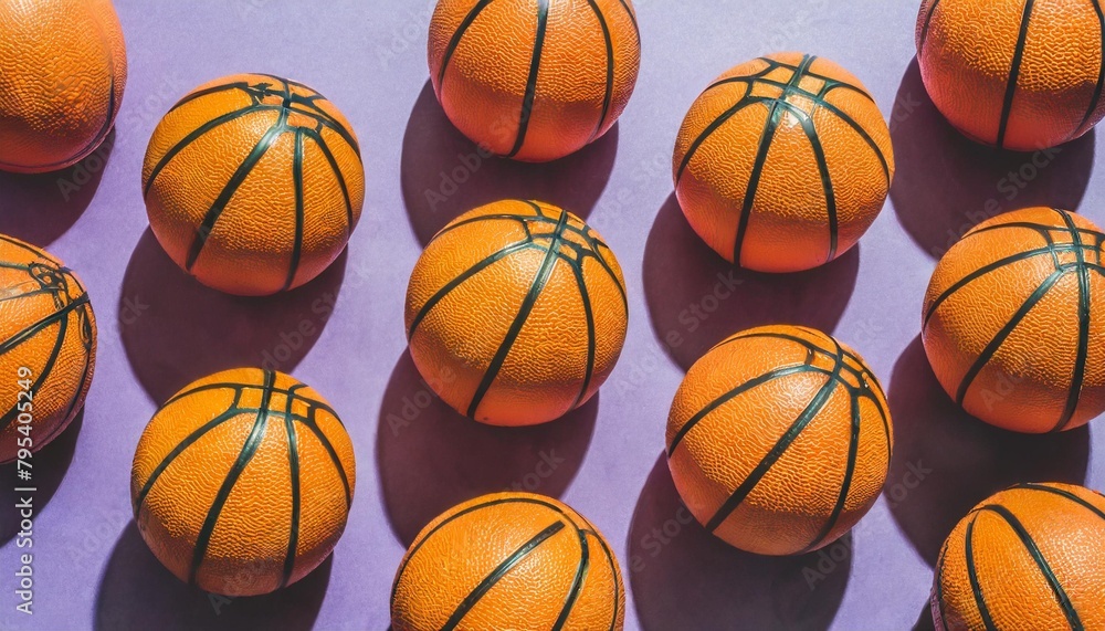 pattern of arranged orange basketballs with basketball text on purple background sports equipment concept