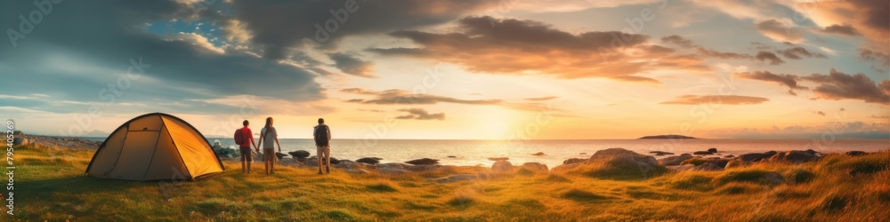 Obraz premium family vacation Camping with a tent amid nature at sunset Man and children near the seashore See the view at sunset