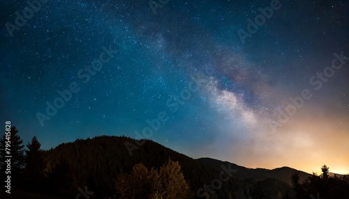 horizontal banner milky way night panorama with silhuettes of mountains and trees