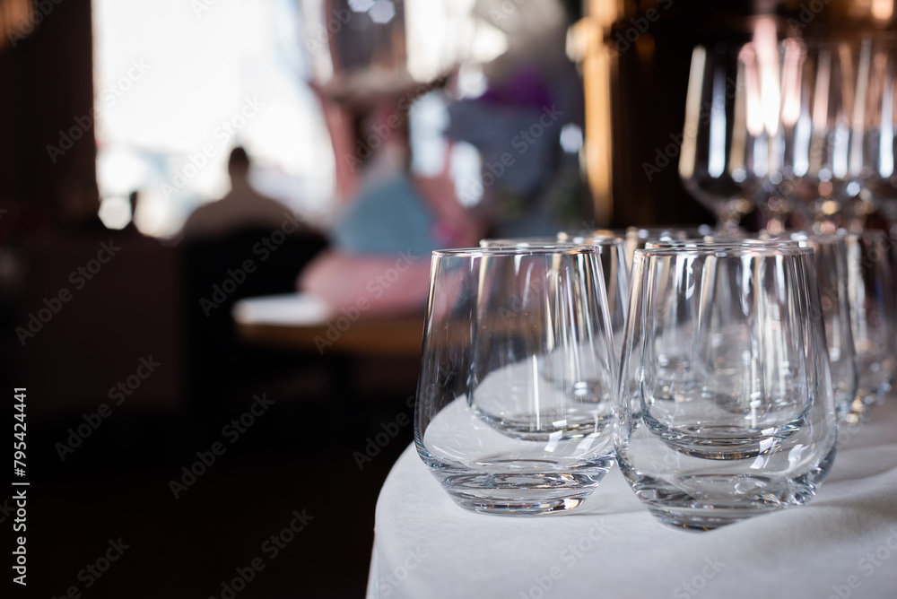 Glass glasses at an event. Catering and table setting for weddings and birthdays