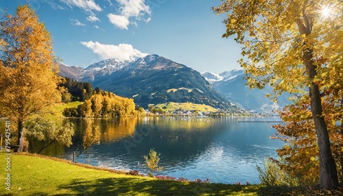 landscape with alps and zeller see in zell am see salzburger land austria beautiful sunny day in alps wonderlust view of highland lake with autumn trees under sunlight and perfect sky photo