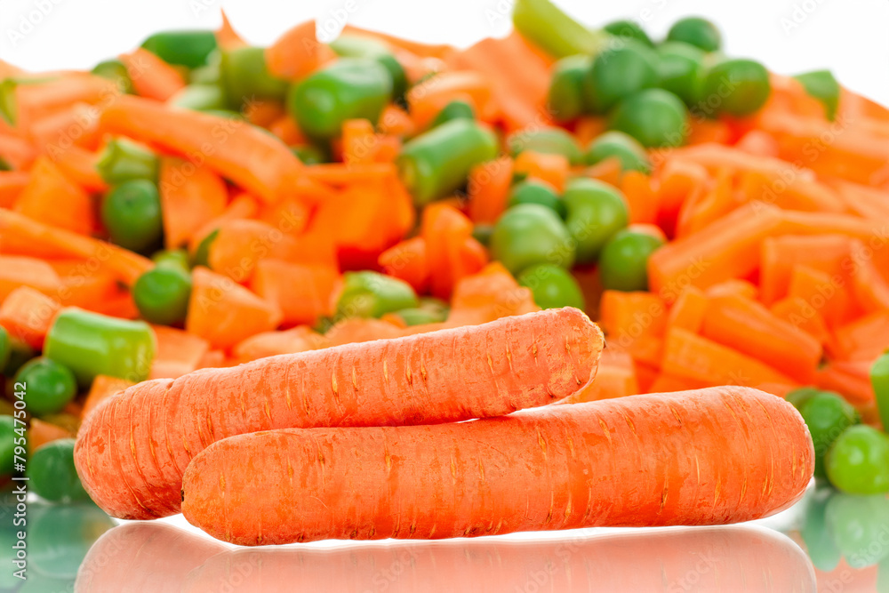 Peeled sweet carrots on the table with vegetables. Peeled sweet carrots on the table with vegetables.