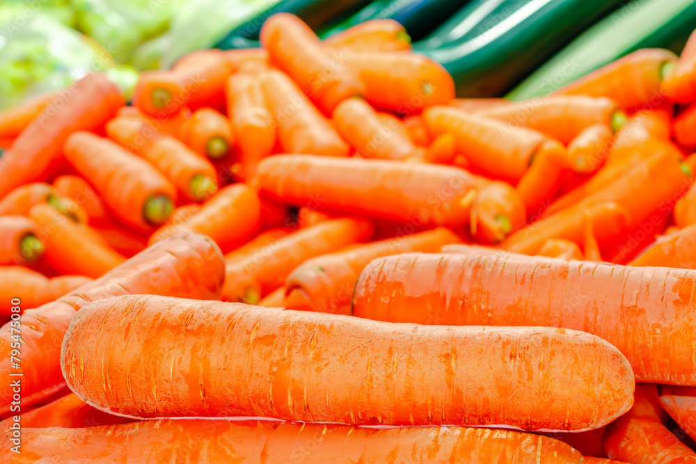 Peeled sweet carrots on the table with vegetables. Peeled sweet carrots on the table with vegetables.