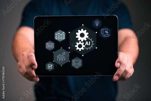 Business Automation and Artificial intelligence for business concept . Man using tablet and touch business automation icon on virtual display screen.