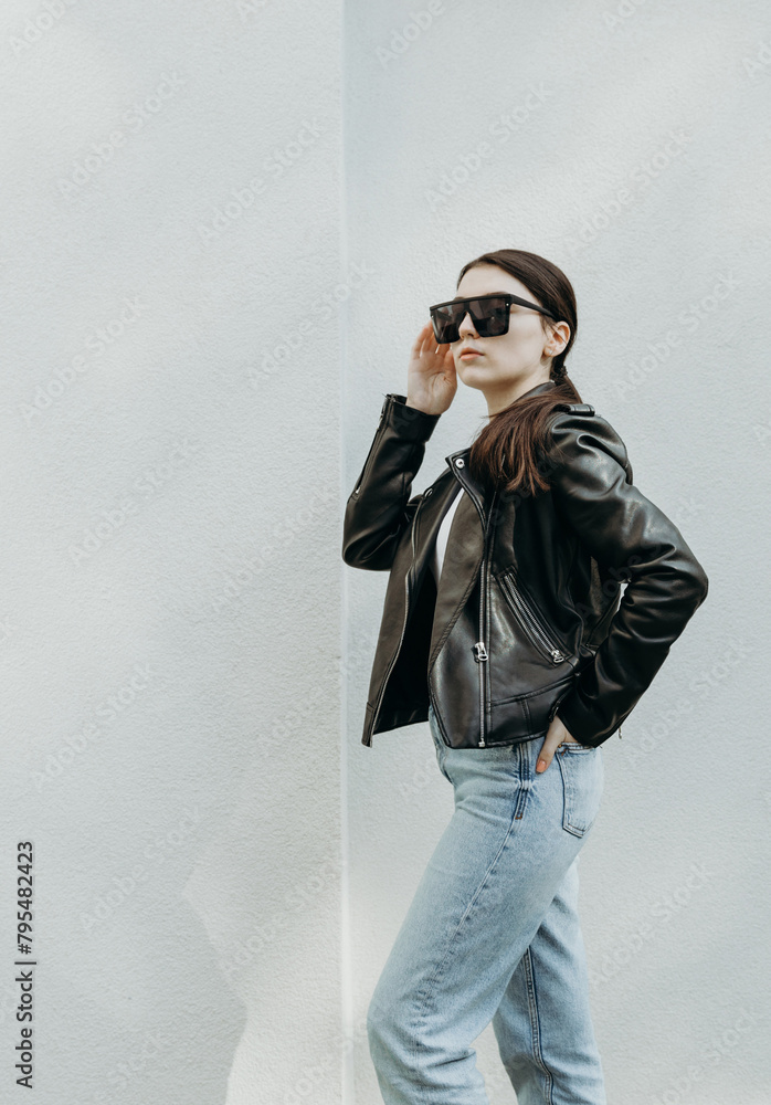 Portrait of a beautiful brunette girl in stylish clothes.