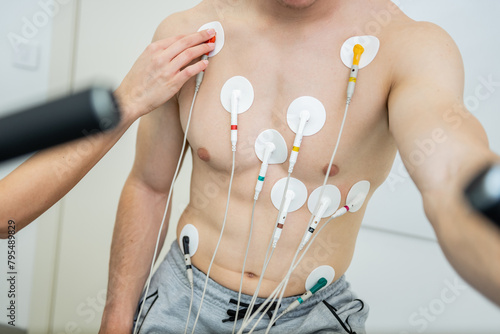 Medical professional conducting a cardiovascular evaluation with ecg electrodes photo