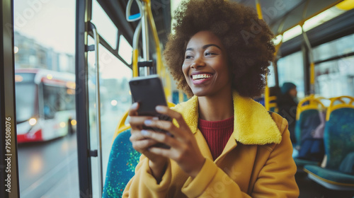 Mulher sorrindo usando o smartphone no transporte publico  photo